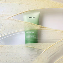Green skincare product with 'anua' branding on a textured beige background