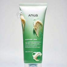 Green skincare product tube with 'Anua' branding on a gray background