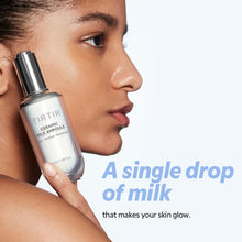 Fragile ceramic milk ampoule held near a woman's face with promotional text.