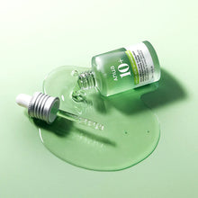 Skincare serum bottle with dropper on a green background
