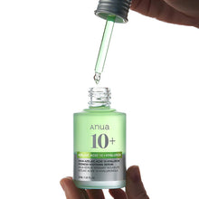 Anua skincare serum bottle with dropper on a white background