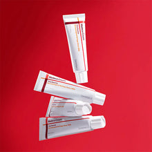Multiple tubes of Madeca Cream on a red background