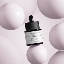 COSRX The Niacinamide 15 Serum 20ml – front of the pack: dropper bottle among pink spheres | Korean Skincare Pakistan