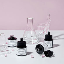 COSRX The Niacinamide 15 Serum 20ml – four serum bottles with lab glassware | Korean Skincare Pakistan