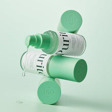 Purito Seoul Wonder Releaf Centella Serum Unscented 60ml – stacked bottles with serum dripping | Korean Skincare Pakistan